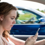woman demonstrating three types of distracted driving by texting while driving woman demonstrating three types of distracted driving by texting while driving
